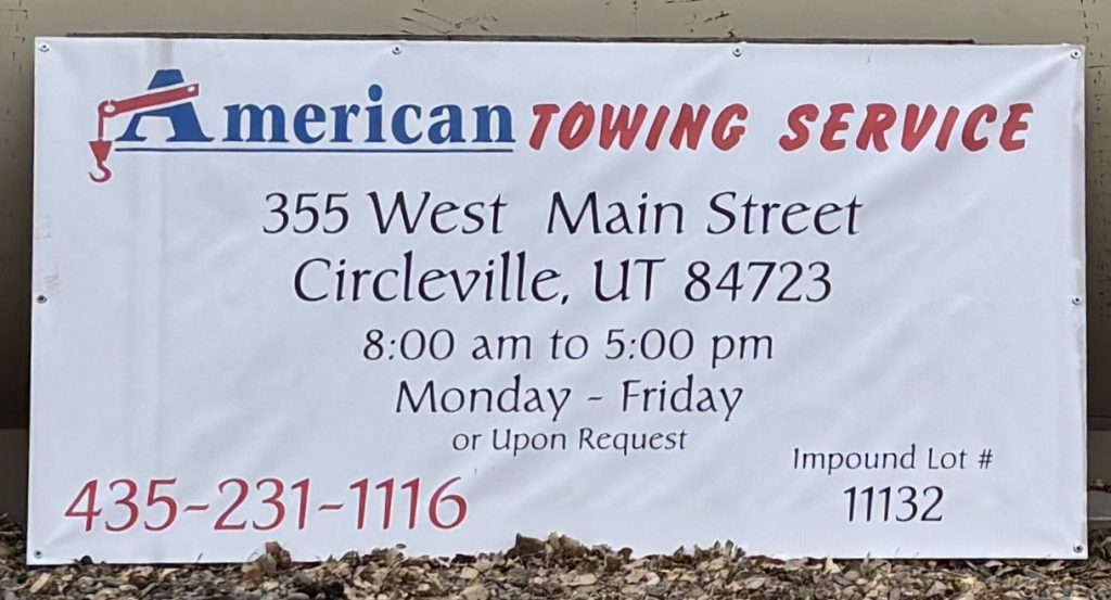 American Towing Service office sign with contact details in Circleville, Utah.