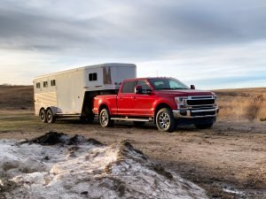 Red truck towing horse trailer