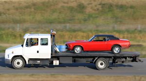 Tow Truck Hauling A New Red Car