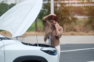 Woman driver using mobile phone during problem car.