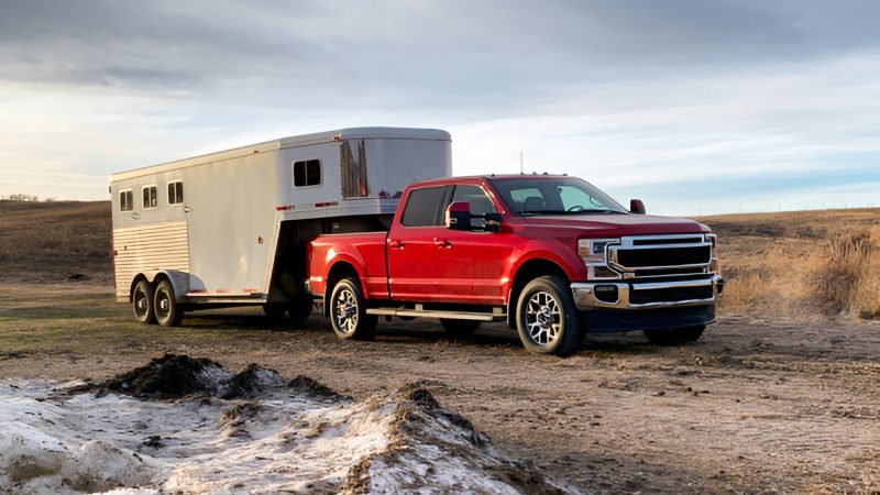 Red truck towing horse trailer